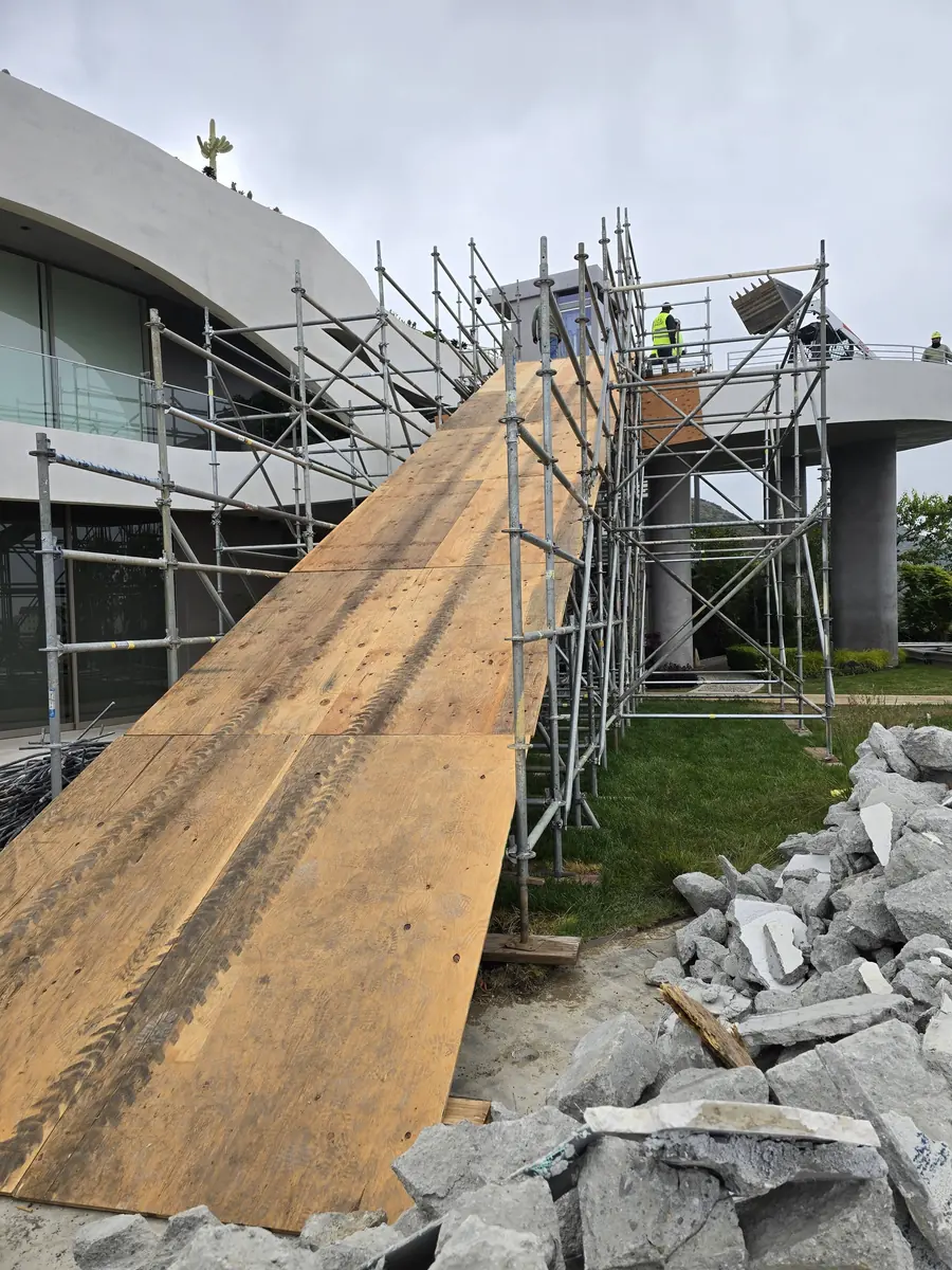 Plywood-decked scaffold access ramp along a building under construction in Ontario, California